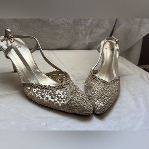 STUART WEITZMAN gold low heel strap shoes.